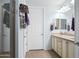 Well-lit bathroom with double sink vanity and a linen closet, next to an enclosed shower space at 26336 W Tina Ln, Buckeye, AZ 85396