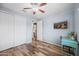 Bright bedroom with wood floors, white closets, and a modern desk area, offering a versatile and comfortable space at 26336 W Tina Ln, Buckeye, AZ 85396