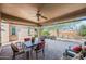 Inviting covered patio with comfortable seating and dining area, seamlessly blending indoor and outdoor living spaces at 26336 W Tina Ln, Buckeye, AZ 85396