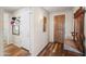 Welcoming entryway with hardwood floors, coat rack, and convenient access to a side door at 26336 W Tina Ln, Buckeye, AZ 85396