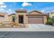 Charming single-story home with a well-manicured front yard and attached two-car garage at 26336 W Tina Ln, Buckeye, AZ 85396