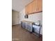 Organized garage featuring cabinets, a work bench, and a utility sink at 26336 W Tina Ln, Buckeye, AZ 85396