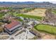 Aerial view of the community golf course and parking lot with golf carts, all surrounded by desert landscape at 26336 W Tina Ln, Buckeye, AZ 85396