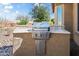 Built-in outdoor kitchen with a modern stainless steel grill, providing the perfect space for al fresco cooking and entertaining at 26336 W Tina Ln, Buckeye, AZ 85396