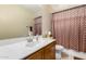 Well-maintained bathroom with a vanity, mirror, toilet, and a shower with patterned curtain at 31527 N Sundown N Dr, San Tan Valley, AZ 85143