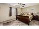 Spacious bedroom featuring a ceiling fan, window with blinds, and a dark wooden sleigh bed and matching furniture at 31527 N Sundown N Dr, San Tan Valley, AZ 85143