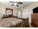 Bedroom featuring a ceiling fan, closet with sliding doors, and traditional wood furniture including a dresser and a bed at 31527 N Sundown N Dr, San Tan Valley, AZ 85143