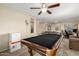 Large recreation room with a pool table, TV, ceiling fan, and comfortable seating perfect for relaxation at 31527 N Sundown N Dr, San Tan Valley, AZ 85143