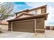 Close up of the garage, showing the concrete driveway and light fixtures at 31527 N Sundown N Dr, San Tan Valley, AZ 85143