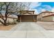 Two-story home featuring a two-car garage with a long driveway and desert landscaping at 31527 N Sundown N Dr, San Tan Valley, AZ 85143