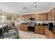 Kitchen features stainless appliances, granite countertops, wooden cabinets, and tile floors at 31527 N Sundown N Dr, San Tan Valley, AZ 85143