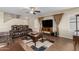 Living room with tile floors, fan, TV, console, curtains, and a comfy, reclining sofa at 31527 N Sundown N Dr, San Tan Valley, AZ 85143