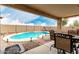 Inviting outdoor living space with a private pool, covered patio, and stylish seating for relaxing or entertaining at 31527 N Sundown N Dr, San Tan Valley, AZ 85143