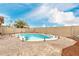 Backyard features an in-ground pool, desert landscaping, and a secure block fence for private outdoor enjoyment at 31527 N Sundown N Dr, San Tan Valley, AZ 85143