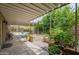 Back patio with shade covering, planters, and a lush garden view for serene outdoor living at 3224 W Ironwood Dr, Phoenix, AZ 85051