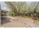 Backyard with mature trees, rock landscaping, and a covered patio providing a tranquil outdoor retreat at 3224 W Ironwood Dr, Phoenix, AZ 85051