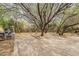 Secluded backyard featuring mature trees, brick patio and unique landscaping with a garden, perfect for relaxing outdoors at 3224 W Ironwood Dr, Phoenix, AZ 85051