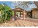Outdoor patio area with brick pillars, grill, and lush cacti landscaping enhancing this backyard space at 3224 W Ironwood Dr, Phoenix, AZ 85051
