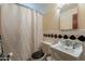 Functional bathroom with vintage style sink, tiled accents, and tub shower with curtain at 3224 W Ironwood Dr, Phoenix, AZ 85051