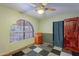 A cozy bedroom showcasing an arched window, unique flooring, and a convenient desk at 3224 W Ironwood Dr, Phoenix, AZ 85051