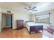 Bedroom features wood-look floors, ceiling fan, large window and furnishings at 3224 W Ironwood Dr, Phoenix, AZ 85051