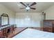 Spacious bedroom featuring a ceiling fan, laminate floors, and plentiful closet space at 3224 W Ironwood Dr, Phoenix, AZ 85051