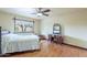 Cozy bedroom featuring wood floors, ceiling fan, and a window bringing in natural light at 3224 W Ironwood Dr, Phoenix, AZ 85051