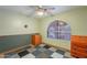 Comfortable bedroom with an arched window, colorful carpet tiles, and ample dresser space at 3224 W Ironwood Dr, Phoenix, AZ 85051