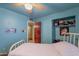 Serene blue bedroom with a bed, closet, and convenient access to a hallway at 3224 W Ironwood Dr, Phoenix, AZ 85051