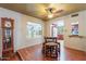 Charming dining area featuring wood floors, ceiling fan, and views into living room and kitchen at 3224 W Ironwood Dr, Phoenix, AZ 85051