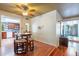 Open dining area featuring hardwood floors, a ceiling fan, and view into the kitchen and living room at 3224 W Ironwood Dr, Phoenix, AZ 85051