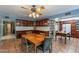 Kitchen showcasing dark wood cabinetry, tile floors, and a ceiling fan above a dining table at 3224 W Ironwood Dr, Phoenix, AZ 85051