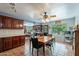 Open concept kitchen features dark wood cabinets, tile floors, and plenty of natural light at 3224 W Ironwood Dr, Phoenix, AZ 85051