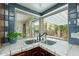 A view of the kitchen sink and tile backsplash looking out to the backyard at 3224 W Ironwood Dr, Phoenix, AZ 85051