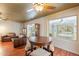 Inviting living room with ceiling fan, wood floors, and dining table, with a sliding door to the outside at 3224 W Ironwood Dr, Phoenix, AZ 85051