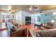 Inviting living room featuring hardwood floors, ceiling fan, leather furniture, and view into kitchen at 3224 W Ironwood Dr, Phoenix, AZ 85051