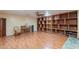 Spacious living room with hardwood floors, built in shelving, and a piano creating an inviting and functional space at 3224 W Ironwood Dr, Phoenix, AZ 85051