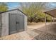 Durable shed with double doors for storage, complemented by stone landscaping in the expansive backyard at 3224 W Ironwood Dr, Phoenix, AZ 85051