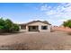 This backyard features a covered patio and a low-maintenance gravel landscape, perfect for outdoor enjoyment at 3253 N 138Th Ave, Avondale, AZ 85392