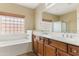 Bathroom with double sinks and a tub at 3253 N 138Th Ave, Avondale, AZ 85392