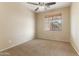 Bedroom features neutral carpet, a ceiling fan, and a window at 3253 N 138Th Ave, Avondale, AZ 85392