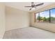 Bright bedroom with a ceiling fan and large window overlooking the yard at 3253 N 138Th Ave, Avondale, AZ 85392