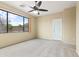 Bedroom with a ceiling fan and large window at 3253 N 138Th Ave, Avondale, AZ 85392