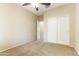 Bedroom with a ceiling fan, neutral carpet, and a closet with sliding doors at 3253 N 138Th Ave, Avondale, AZ 85392