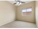 Bright bedroom with a ceiling fan, neutral carpet, and a window at 3253 N 138Th Ave, Avondale, AZ 85392
