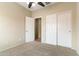 Bedroom with a ceiling fan, neutral carpet, and a closet with sliding doors at 3253 N 138Th Ave, Avondale, AZ 85392