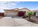 Charming single-story home with a well-manicured front yard, desert landscaping, and an attached two-car garage at 3253 N 138Th Ave, Avondale, AZ 85392