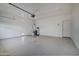 A spacious two-car garage featuring ample storage space, bright lighting, and an epoxy-coated floor at 3253 N 138Th Ave, Avondale, AZ 85392