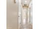 Hallway with tile flooring leading to multiple rooms with white doors at 3253 N 138Th Ave, Avondale, AZ 85392