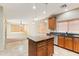 Kitchen island overlooking an adjacent room, light toned wood cabinets, stainless appliances at 3253 N 138Th Ave, Avondale, AZ 85392